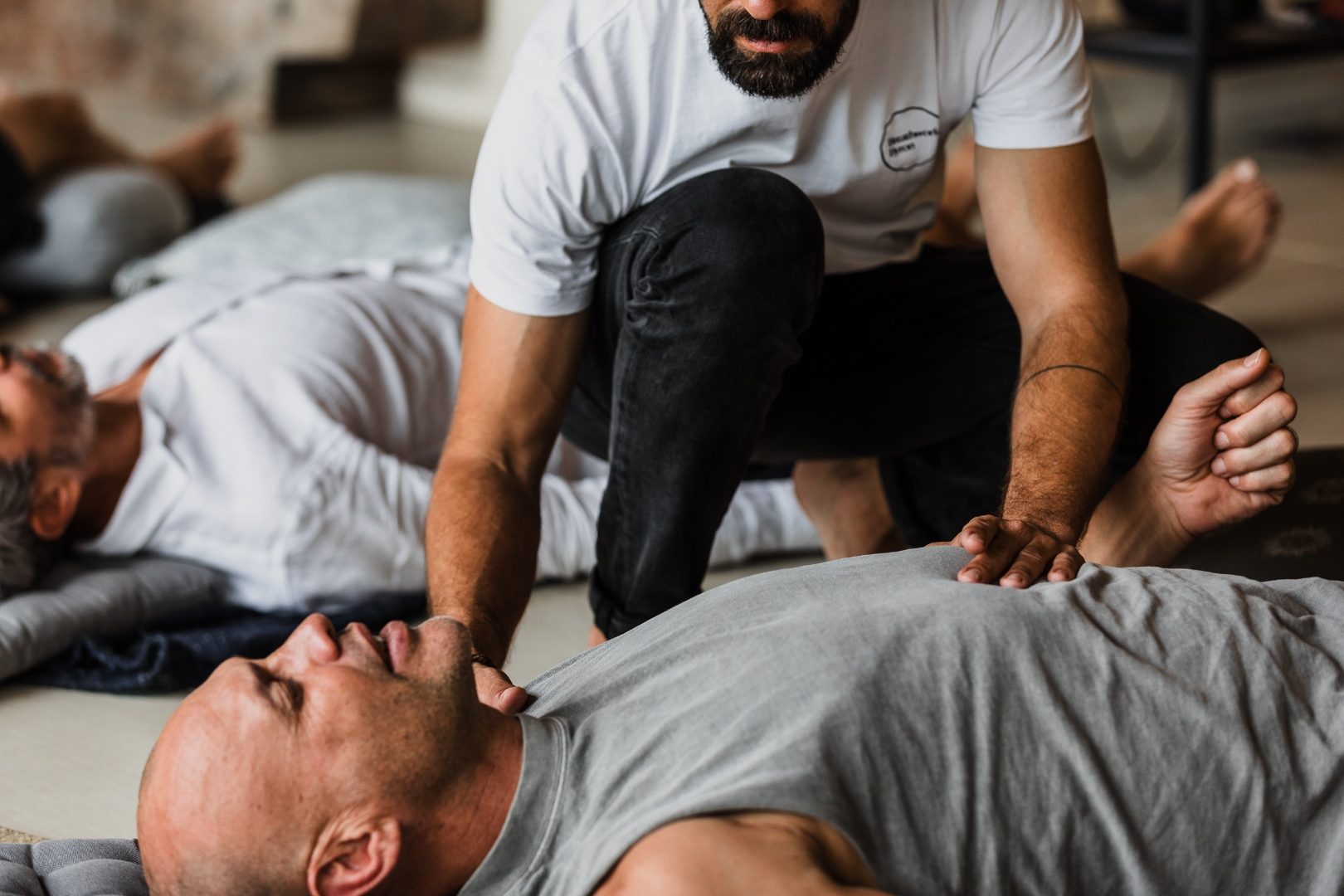 A facilitator guiding a participant one to one during a breathwork session
