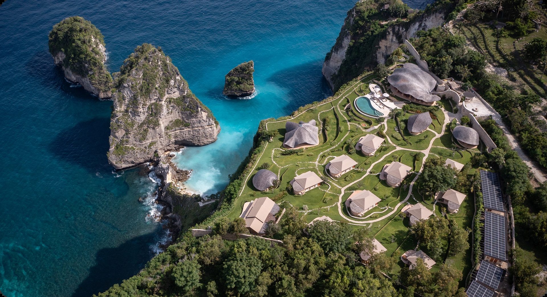 Aerial view of the retreat venue on the cliffs of Nusa Penida, Bali, overlooking turquoise water